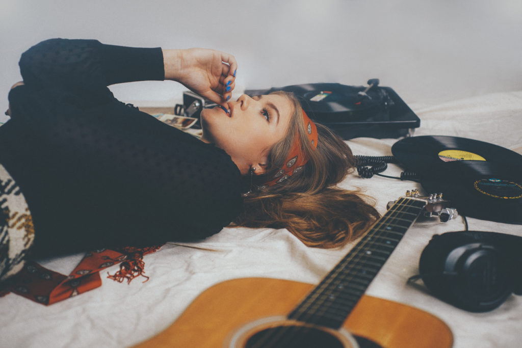 Kerri Medders deep in thought with Vinyl Records Martin Guitar palsey scraf 60's inspires photo shoot