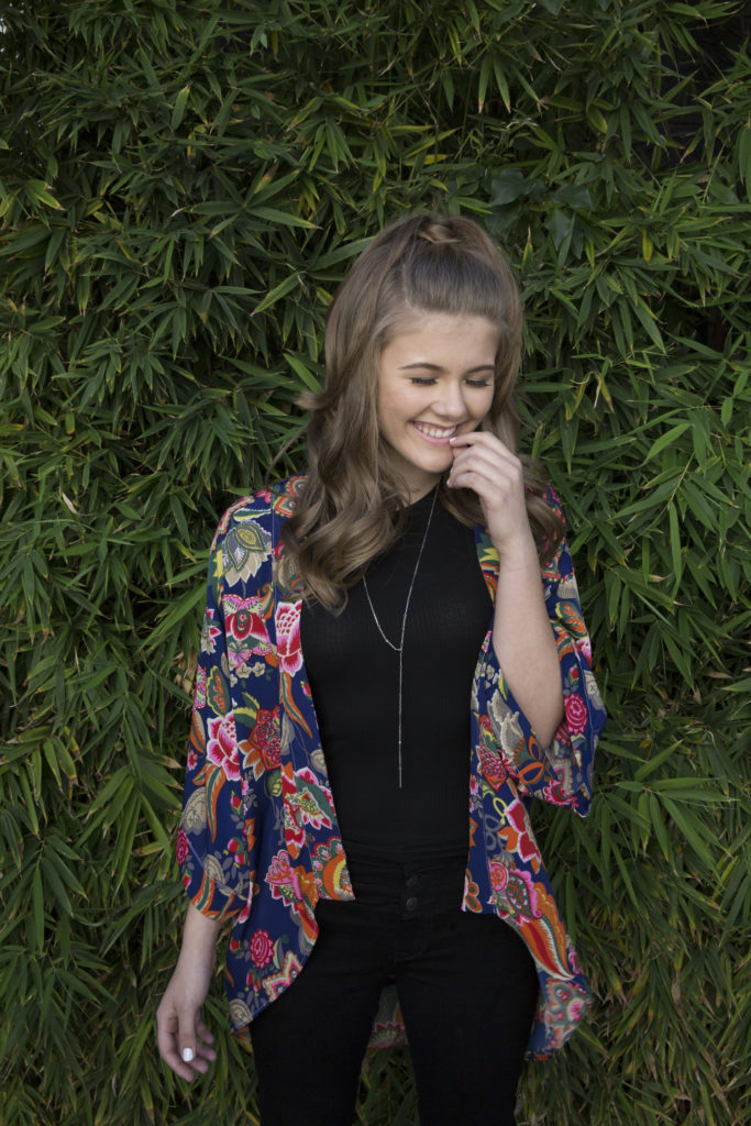 Smiling Kerri Medders photo shoot with Popmania loose curls and natural makeup and flower kimono